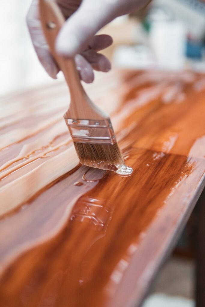 painting a table with paint brush
